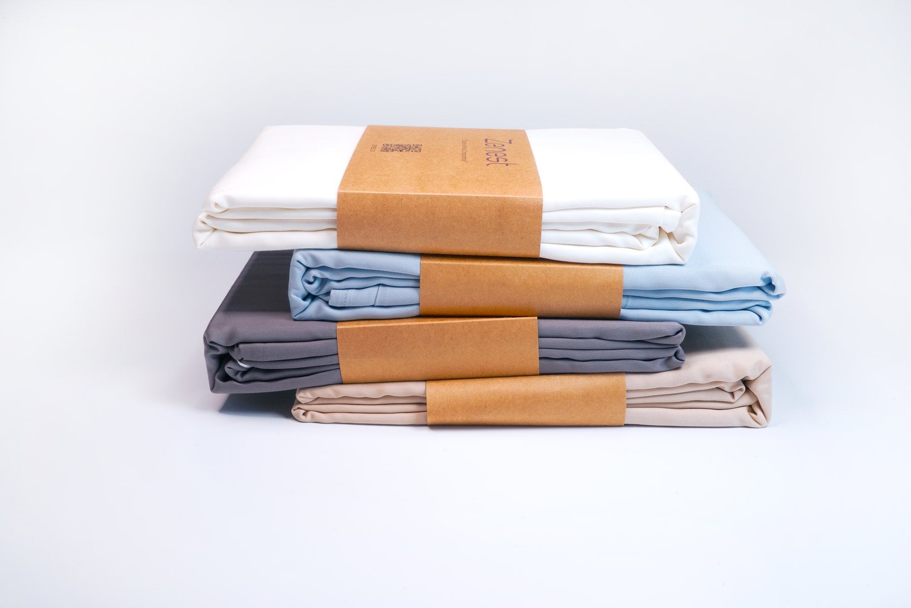 Stacked Zenest sheets in calm colours